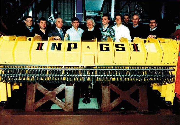 1996. Electron cooler in the SIS-18 synchrotron with the ring radius of 216 m at the Institute for Heavy Ion Research (Germany). This accelerator can accelerate ions up to a velocity of 90 % of the velocity of light. The photograph shows the team of Russian and German physicists participating in the development and fabrication of the cooler 1996. Electron cooler in the SIS-18 synchrotron with the ring radius of 216 m at the Institute for Heavy Ion Research (Germany). This accelerator can accelerate ions up to a velocity of 90 % of the velocity of light. The photograph shows the team of Russian and German physicists participating in the development and fabrication of the cooler