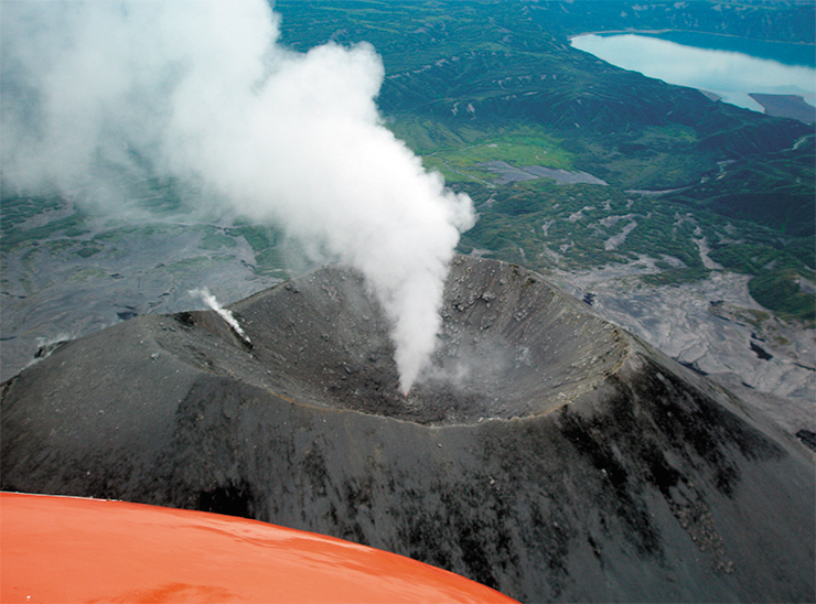 We are leaving the unforgettable Geyser Valley. One of the volcanoes, over which we are flying in the helicopter, is whistling deafeningly and belching smoke after us We are leaving the unforgettable Geyser Valley. One of the volcanoes, over which we are flying in the helicopter, is whistling deafeningly and belching smoke after us