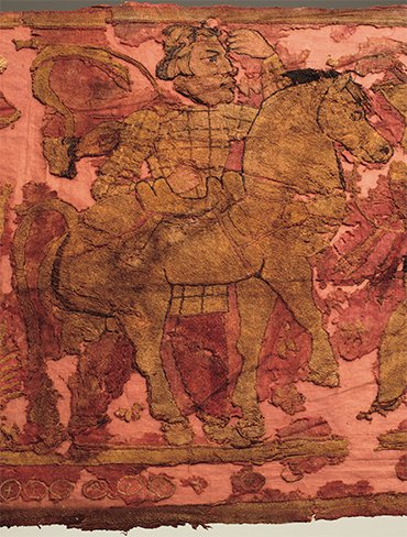Men in Iranian dress, equipped with daggers and long swords, approach the fire