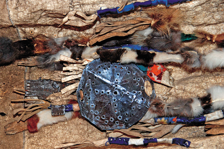 A solar disk and a wooden doll emeget, attributes of a shaman’s costume. The sun lit the shaman woman’s way during her trip across the gloomy Lower World, and the doll served to communicate with the spirits and other inhabitants of the netherworld. The Museum of Local Lore, settlement of Khonuu , Moma ulus, Yakutia A solar disk and a wooden doll emeget, attributes of a shaman’s costume. The sun lit the shaman woman’s way during her trip across the gloomy Lower World, and the doll served to communicate with the spirits and other inhabitants of the netherworld. The Museum of Local Lore, settlement of Khonuu , Moma ulus, Yakutia