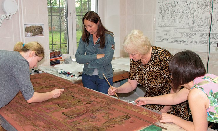 The unique find is reviving thanks to restorers. From left to right: N. P. Sinitsina, a top grade fine art restorer (textiles and leather), head of the Leather Restoration Group with the Department of Non-Conventional Restoration Technologies at the Grabar All-Russian Art, Scientific and Restoration Center (Moscow); Ye. S. Sinitsina, a fine art restorer with the same department; and O. S. Popova, a fabric restorer with the Pushkin State Museum of Fine Arts (Moscow) The unique find is reviving thanks to restorers. From left to right: N. P. Sinitsina, a top grade fine art restorer (textiles and leather), head of the Leather Restoration Group with the Department of Non-Conventional Restoration Technologies at the Grabar All-Russian Art, Scientific and Restoration Center (Moscow); Ye. S. Sinitsina, a fine art restorer with the same department; and O. S. Popova, a fabric restorer with the Pushkin State Museum of Fine Arts (Moscow)