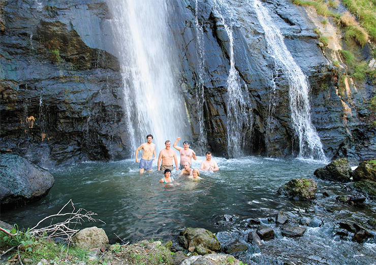 Bathing in the streams of a 30-meter-high waterfall on the Vodopadny brook. An unforgettable feeling: cold water coming from above, steam coming from under the stones aside, and biting hot streams of underground springs burning our heels from below. The Geyser Valley, Kamchatka Bathing in the streams of a 30-meter-high waterfall on the Vodopadny brook. An unforgettable feeling: cold water coming from above, steam coming from under the stones aside, and biting hot streams of underground springs burning our heels from below. The Geyser Valley, Kamchatka
