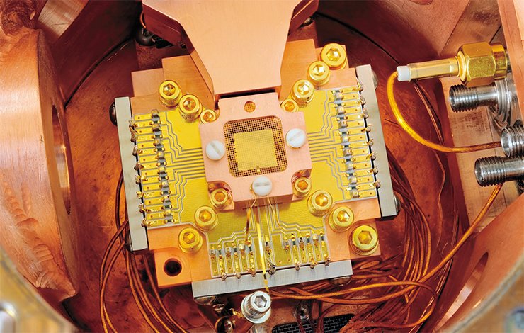 Researchers from the National Institute of Standards and Technology of the USA (NIST) developed a special trap that can confine two beryllium ions located at a distance of 40 µm from each other. The ions are located above a golden plate surrounded by a golden grid and a copper casing for reduction of electrostatic interferences. Credit: Y. Colombe/NIST Researchers from the National Institute of Standards and Technology of the USA (NIST) developed a special trap that can confine two beryllium ions located at a distance of 40 µm from each other. The ions are located above a golden plate surrounded by a golden grid and a copper casing for reduction of electrostatic interferences. Credit: Y. Colombe/NIST