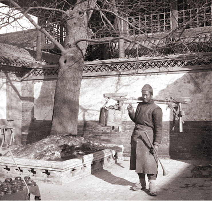 A peddler in the courtyard of a traditional house. Even today, on the streets of some Chinese cities, you can still see people carrying luggage on straight yokes like the one in the photo. 1909. Photo by A. Dutertre A peddler in the courtyard of a traditional house. Even today, on the streets of some Chinese cities, you can still see people carrying luggage on straight yokes like the one in the photo. 1909. Photo by A. Dutertre
