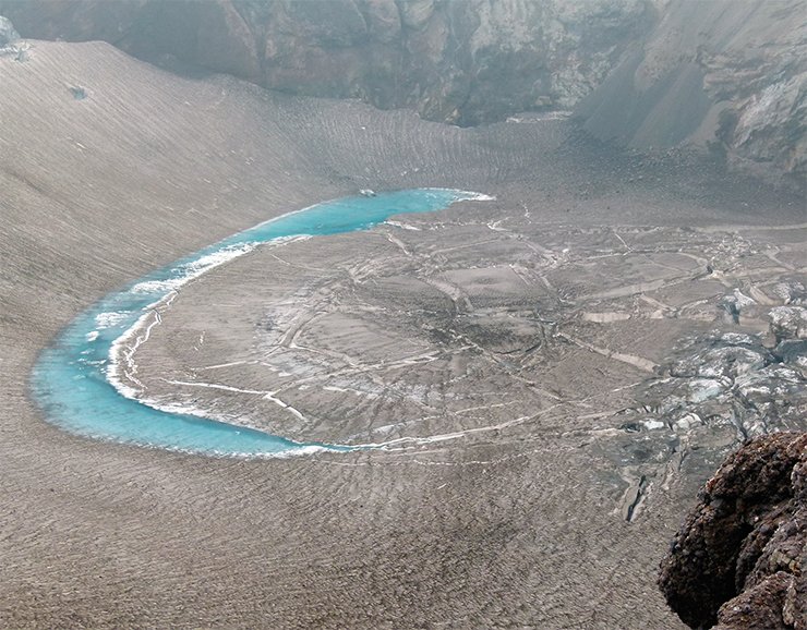 This solidified lake is located in one of the craters of the Mutnovsky Volcano, which belongs to the same magma system as Gorelyi