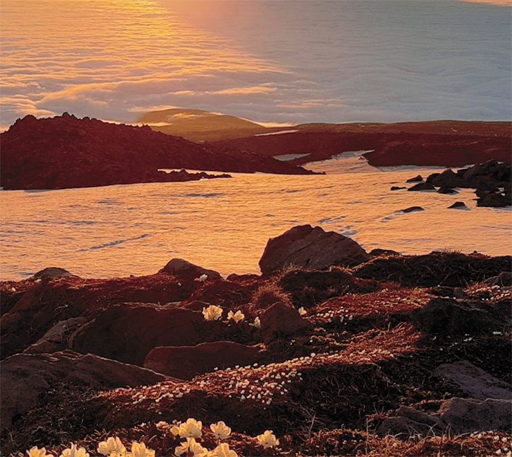 Evening. Alaid Volcano on Atlasov Island wrapped in clouds over the Sea of Okhotsk