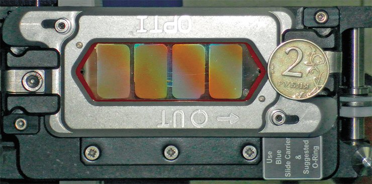 All the existing massively parallel DNA sequencing technologies involve concurrent determination of short nucleotide sequences in millions of microscopic reaction sites. Photo shows a flow-through cell of the SOLiD genome sequencer. Each brown spot houses 90 million reaction sites. Photo by the courtesy of E. Brenner