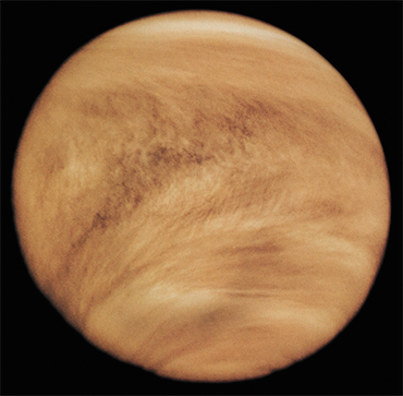 Clouds in the atmosphere of Venus are composed of tiny droplets of highly concentrated sulfuric acid. The V-shape of the clouds is due to the strong winds blowing near the equator. Because of the dense cloud layer, the Venusian surface can be observed only in radio and microwave bands and in some regions of the near infrared. This image of the Venusian surface was made by Pioneer Venus 1 in the ultraviolet rays in 1979. Credit: NASA Clouds in the atmosphere of Venus are composed of tiny droplets of highly concentrated sulfuric acid. The V-shape of the clouds is due to the strong winds blowing near the equator. Because of the dense cloud layer, the Venusian surface can be observed only in radio and microwave bands and in some regions of the near infrared. This image of the Venusian surface was made by Pioneer Venus 1 in the ultraviolet rays in 1979. Credit: NASA